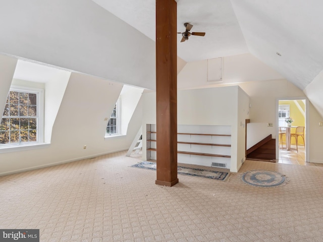 bonus room featuring light carpet, vaulted ceiling, ceiling fan, and a healthy amount of sunlight