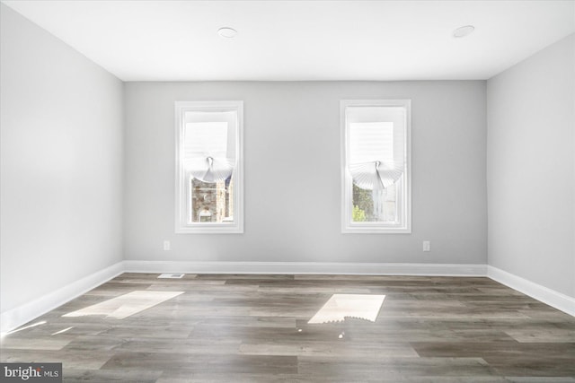 spare room featuring dark hardwood / wood-style flooring