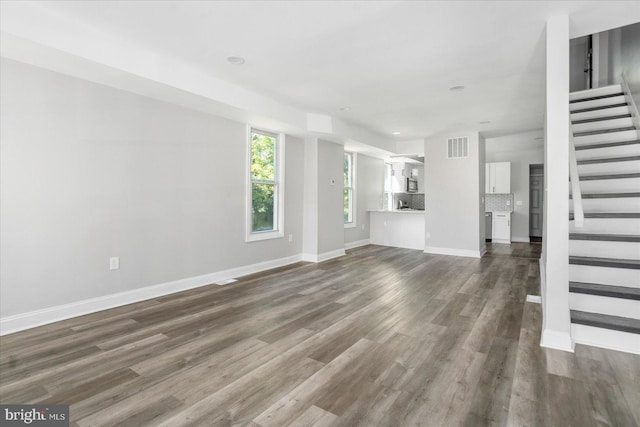 unfurnished living room with hardwood / wood-style floors