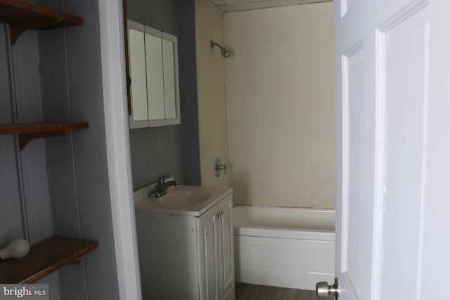 bathroom featuring vanity, hardwood / wood-style flooring, and bathtub / shower combination