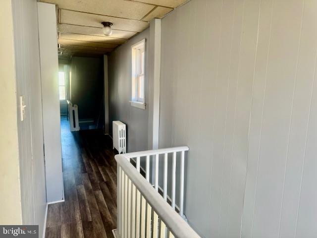 hallway featuring dark hardwood / wood-style flooring and radiator heating unit