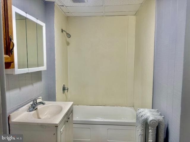 bathroom featuring radiator, a paneled ceiling, and vanity