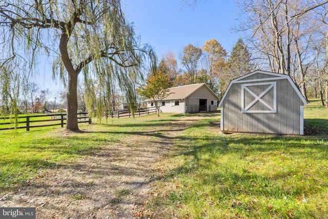 view of yard featuring a rural view and a shed