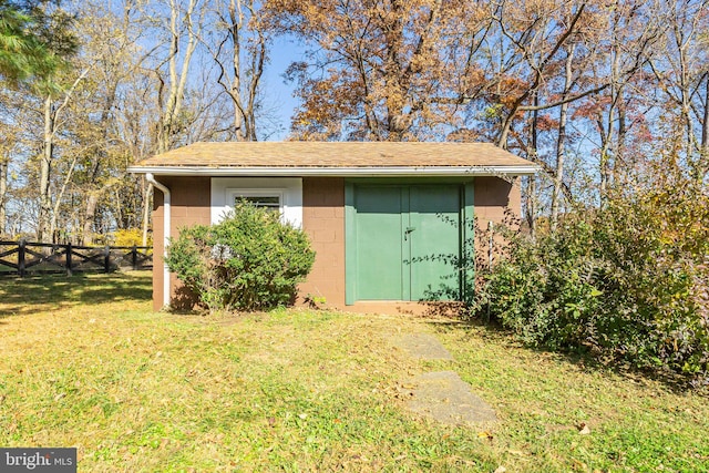 view of outdoor structure featuring a lawn