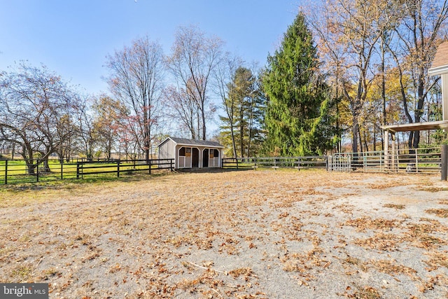 view of yard with a rural view and an outdoor structure