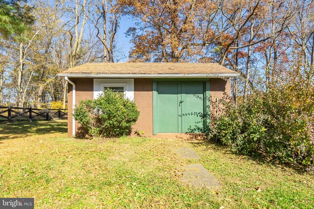 view of outbuilding featuring a lawn