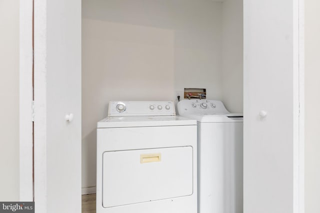 laundry area with independent washer and dryer