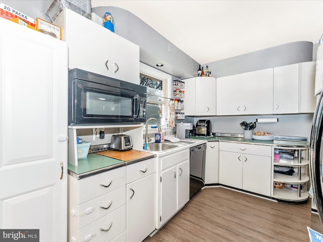 kitchen featuring white cabinets, light wood-type flooring, stainless steel dishwasher, and sink