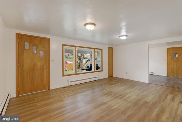 entrance foyer with light hardwood / wood-style floors and baseboard heating