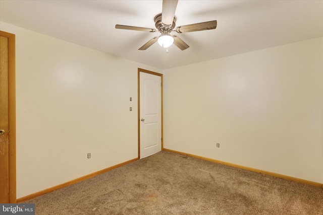 carpeted spare room featuring ceiling fan