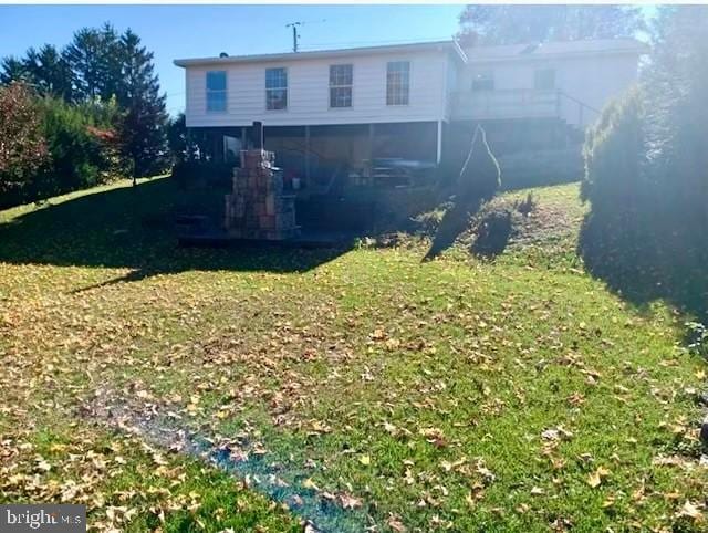 rear view of house featuring a lawn