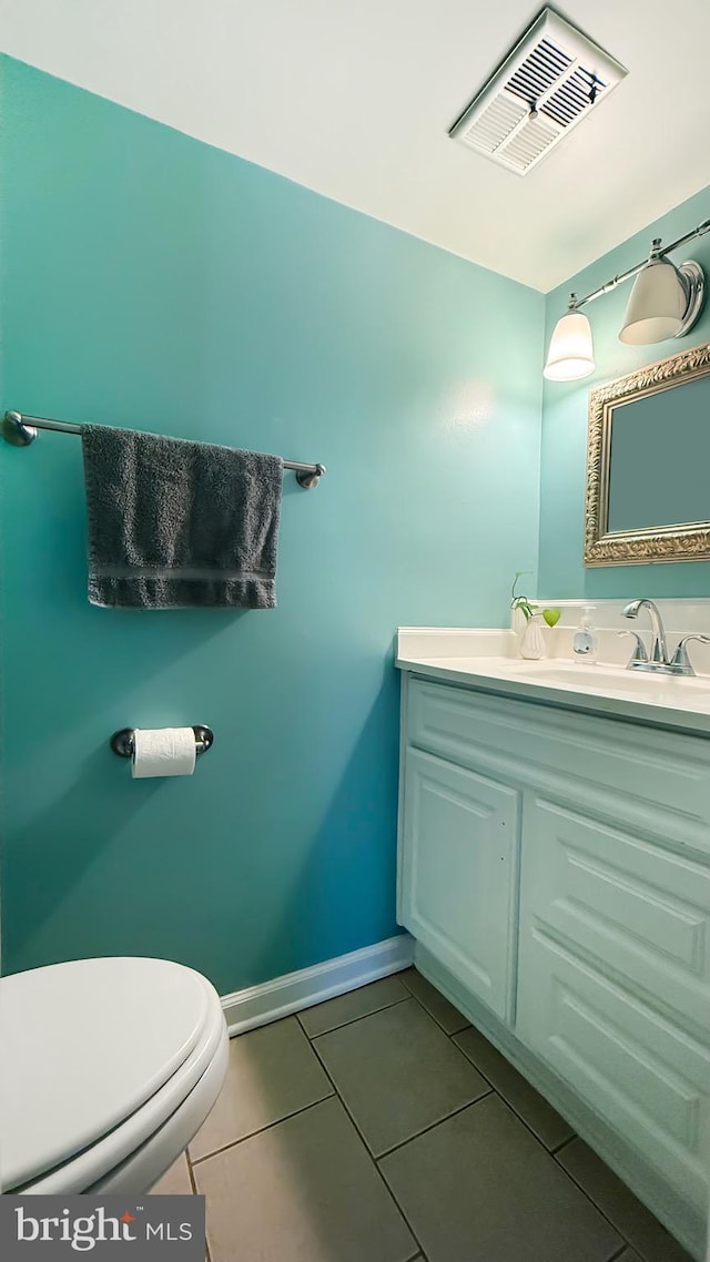 bathroom with tile patterned floors, vanity, and toilet