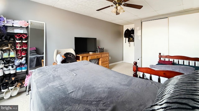 bedroom featuring light carpet, a closet, and ceiling fan