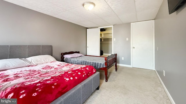 bedroom with carpet, a spacious closet, and a closet