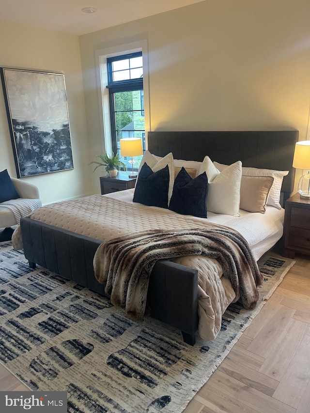 bedroom with light parquet flooring