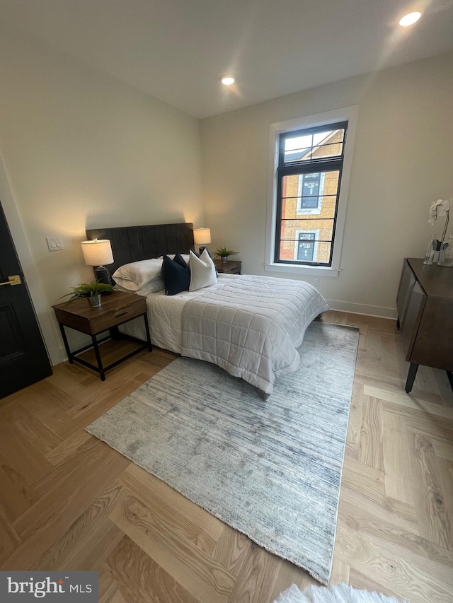 bedroom with light parquet floors