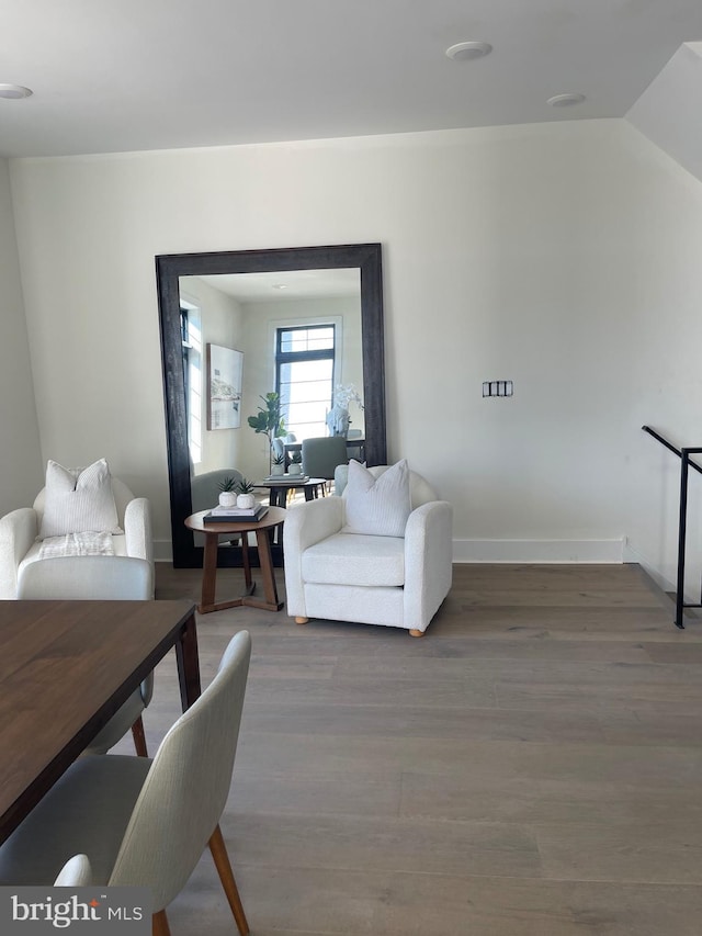 living room featuring hardwood / wood-style flooring and vaulted ceiling