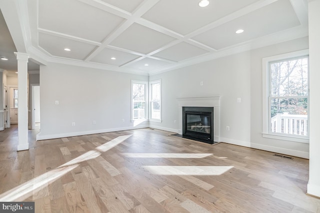 unfurnished living room featuring light hardwood / wood-style floors, a healthy amount of sunlight, ornate columns, and coffered ceiling