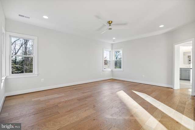 spare room featuring light hardwood / wood-style floors and ceiling fan