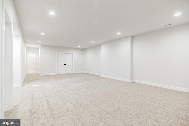 basement featuring light colored carpet