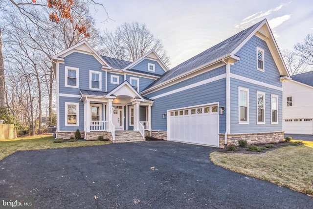 craftsman-style house with a porch and a garage