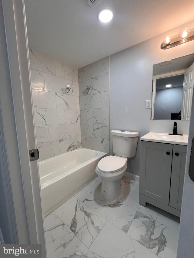 full bathroom with vanity, tiled shower / bath combo, and toilet