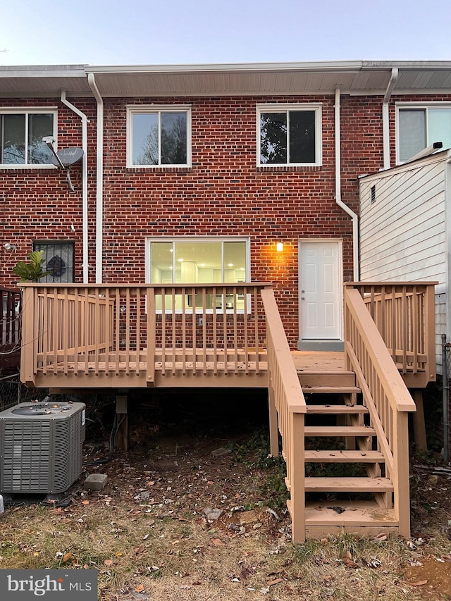 back of house with a wooden deck and central AC unit