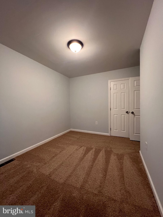 unfurnished room with carpet floors