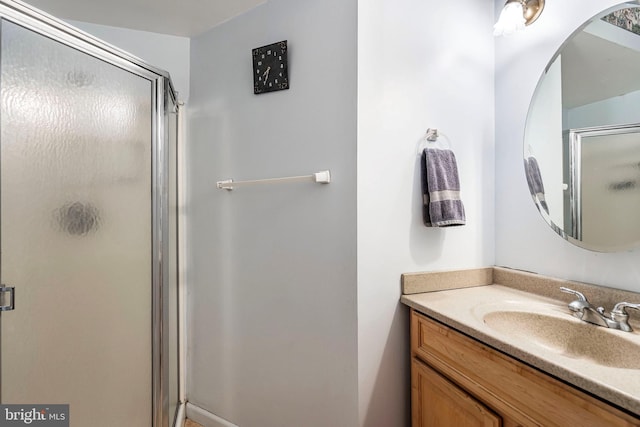 bathroom featuring walk in shower and vanity