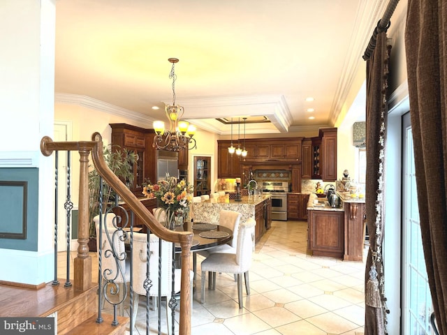 dining space with sink, an inviting chandelier, and crown molding