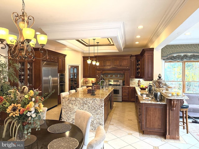 kitchen featuring stainless steel appliances, sink, decorative light fixtures, and crown molding