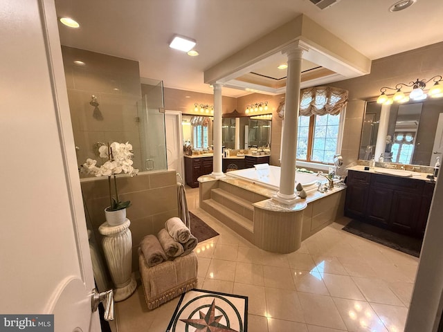 bathroom featuring tile patterned flooring, vanity, ornate columns, and shower with separate bathtub