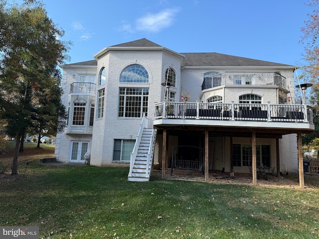 back of property with a wooden deck and a lawn