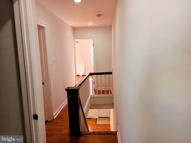 stairs with hardwood / wood-style flooring