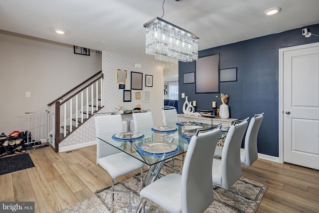 dining room featuring a notable chandelier and light wood-type flooring