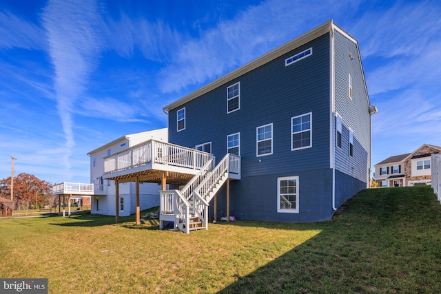 rear view of house featuring a lawn and a wooden deck