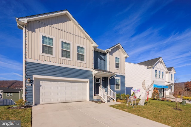 view of property with a garage and a front lawn