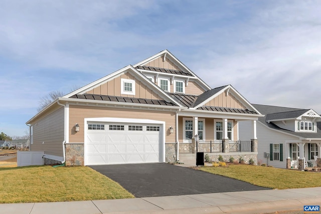 craftsman-style home with a front lawn and a garage