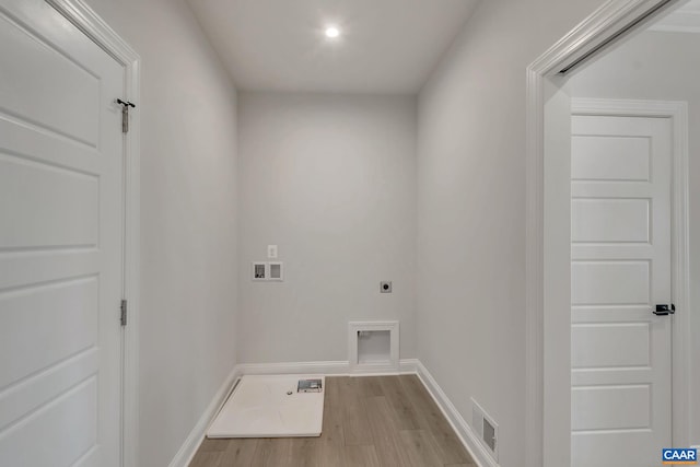 laundry area featuring washer hookup, light wood-type flooring, and electric dryer hookup