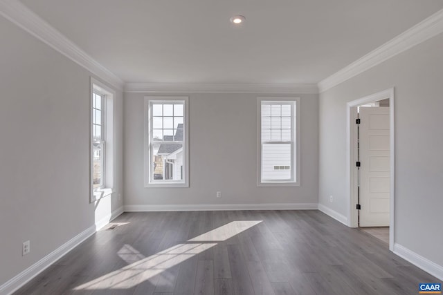 spare room with ornamental molding and dark hardwood / wood-style floors