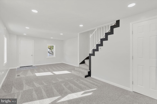 basement featuring light colored carpet