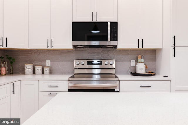 kitchen with white cabinets, decorative backsplash, and stainless steel appliances