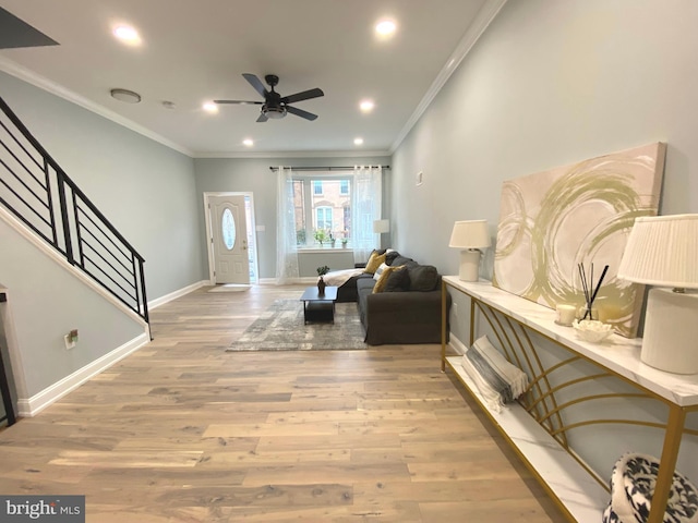 entryway featuring hardwood / wood-style floors, ceiling fan, and crown molding