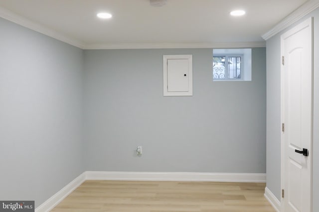 unfurnished room with electric panel, light hardwood / wood-style floors, and ornamental molding