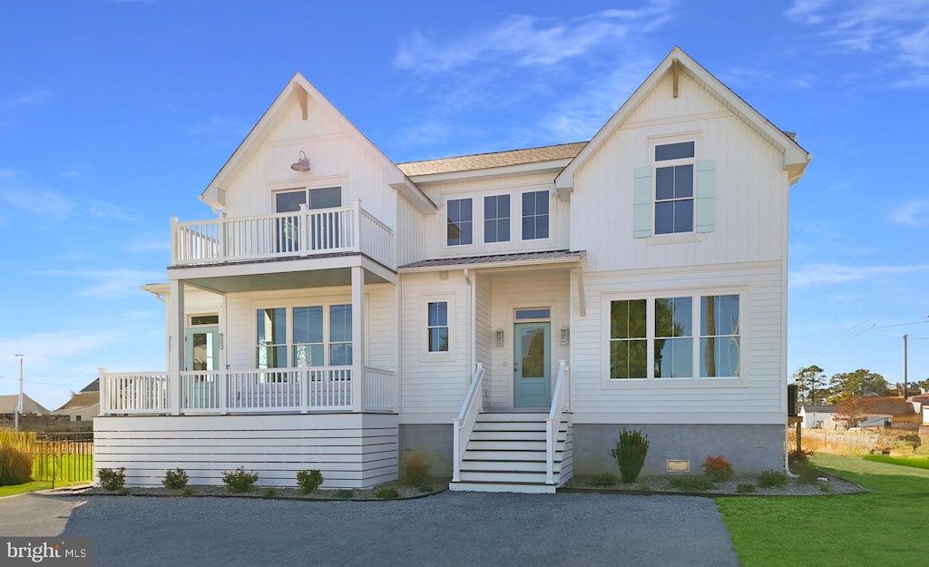 view of front of property with a front lawn and a balcony