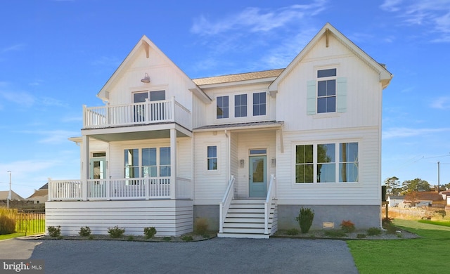 view of front of property with a front lawn and a balcony