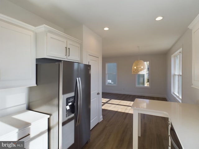 kitchen featuring dark hardwood / wood-style flooring, stainless steel fridge with ice dispenser, decorative light fixtures, and white cabinets