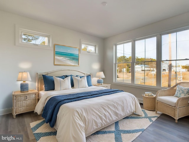 bedroom with dark hardwood / wood-style flooring