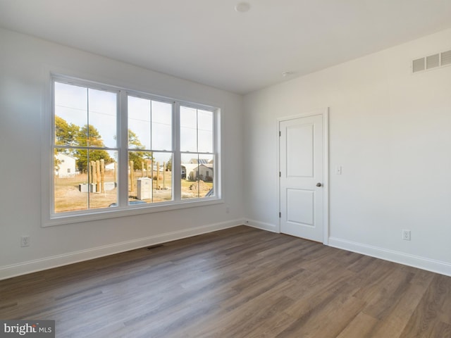 empty room featuring dark hardwood / wood-style flooring