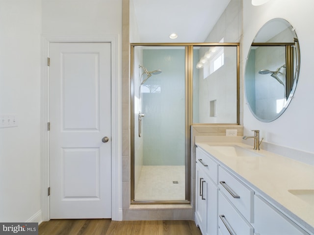 bathroom featuring vanity, hardwood / wood-style floors, and walk in shower